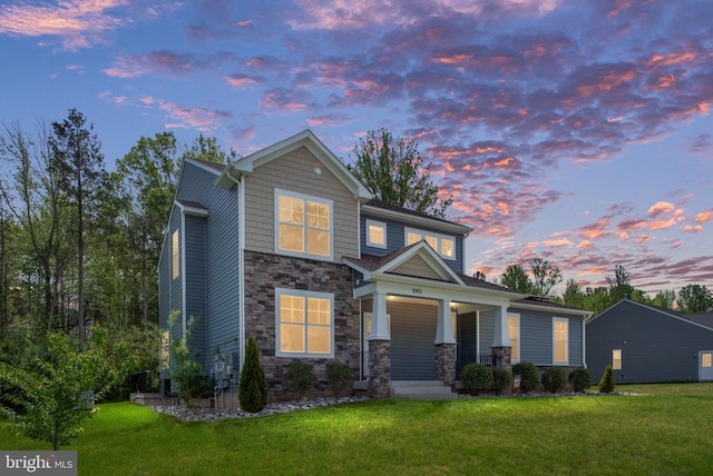 10811 Honorable Ct, Spotsylvania, VA 22553 - view of front facade featuring stone siding, a porch, and a front yard