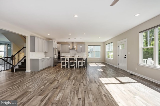 10811 Honorable Ct, Spotsylvania, VA 22553 - kitchen with wall chimney exhaust hood, gray cabinets, high end fridge, dark wood-style flooring, and recessed lighting