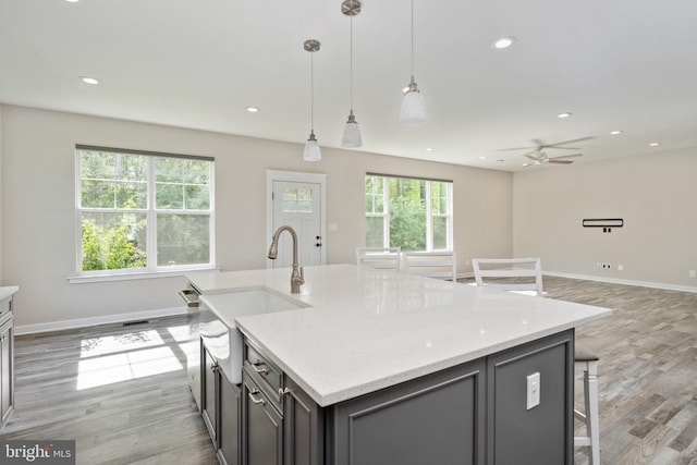 10811 Honorable Ct, Spotsylvania, VA 22553 - kitchen with light wood-style floors, open floor plan, a sink, baseboards, and recessed lighting