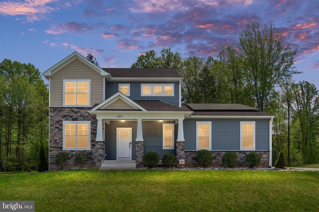 10811 Honorable Ct, Spotsylvania, VA 22553 - craftsman-style house with stone siding, covered porch, solar panels, and a front yard