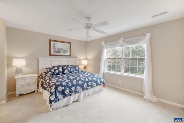 carpeted bedroom featuring visible vents, baseboards, and a ceiling fan