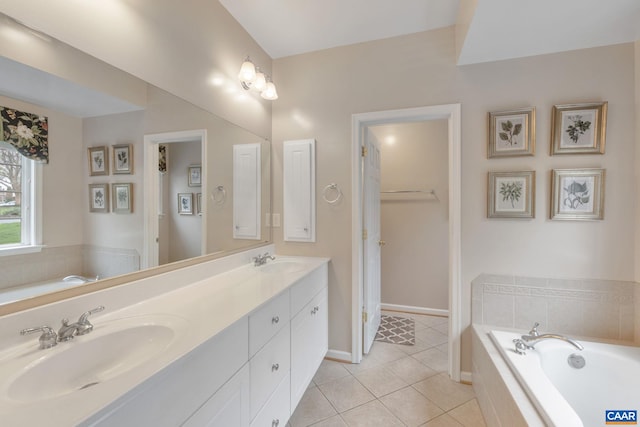 full bath with a bath, tile patterned flooring, double vanity, and a sink