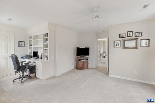 home office with ceiling fan, light carpet, baseboards, and visible vents