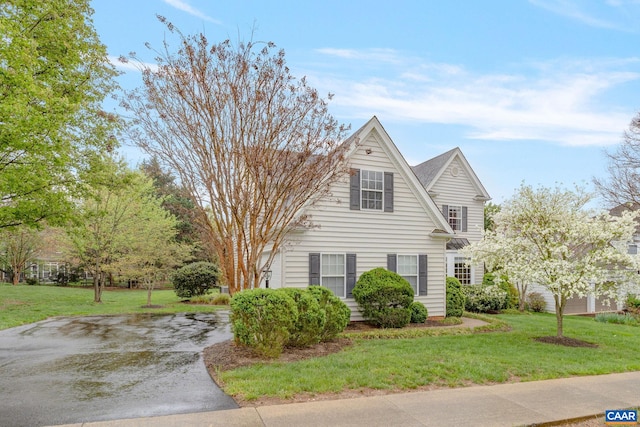 view of property exterior with a lawn