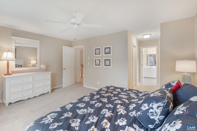 carpeted bedroom featuring baseboards, ensuite bathroom, and ceiling fan