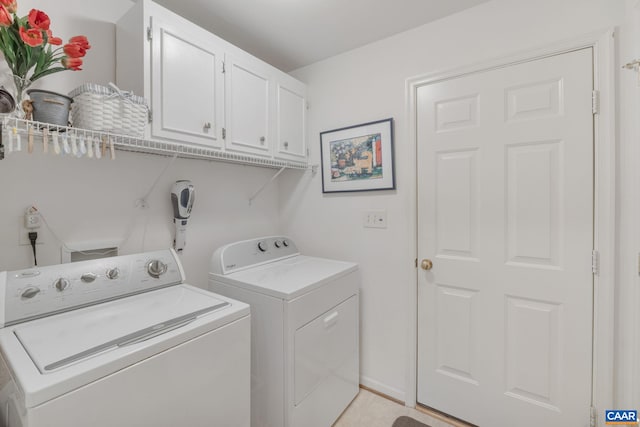 washroom featuring cabinet space and washer and dryer
