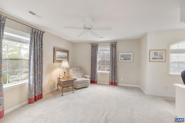 sitting room featuring baseboards, ceiling fan, visible vents, and carpet floors