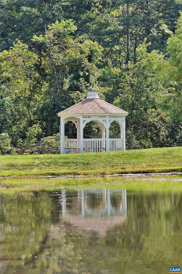 property view of water featuring a forest view and a gazebo