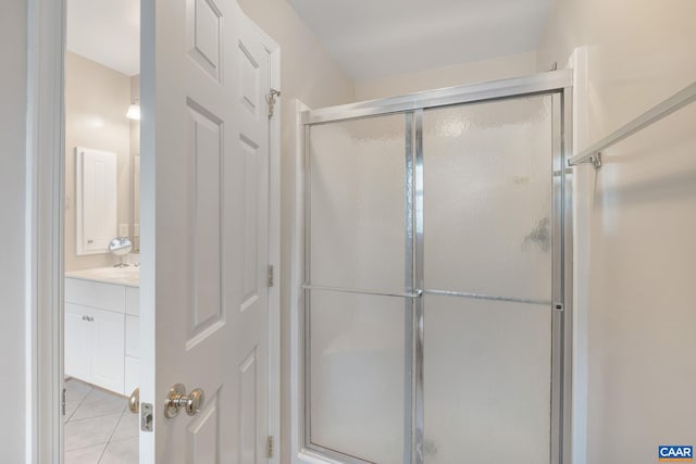 bathroom featuring a stall shower, tile patterned flooring, and vanity