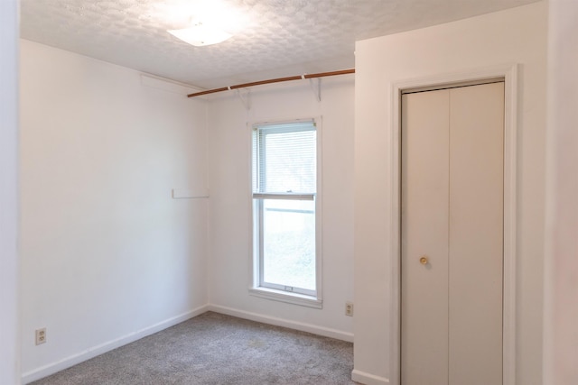 708 Mccorkle Dr, Lexington, VA 24450 - unfurnished bedroom featuring a textured ceiling, multiple windows, light colored carpet, baseboards, and a closet