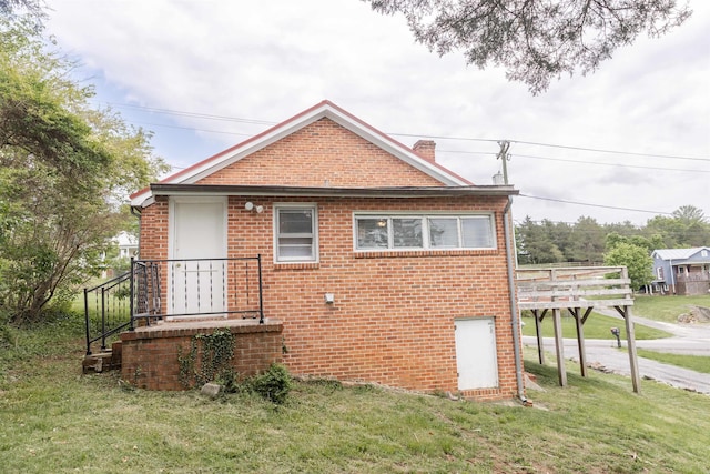 708 Mccorkle Dr, Lexington, VA 24450 - view of side of home featuring brick siding, a lawn, a chimney, and a deck