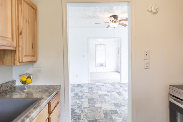 708 Mccorkle Dr, Lexington, VA 24450 - kitchen with light brown cabinetry, a ceiling fan, stone finish flooring, and a sink