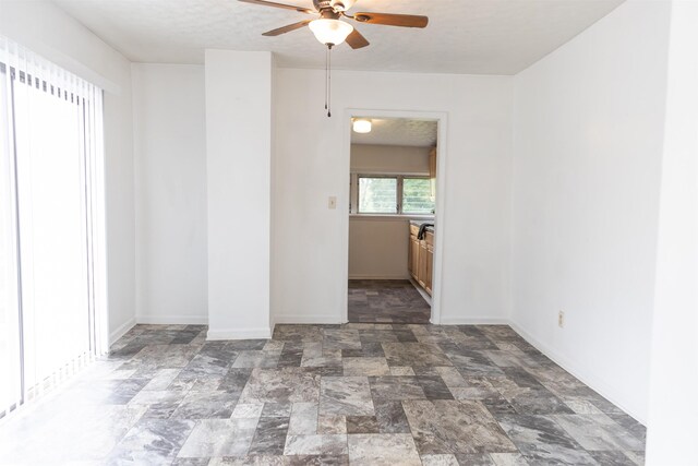 708 Mccorkle Dr, Lexington, VA 24450 - empty room featuring ceiling fan, stone finish floors, and baseboards