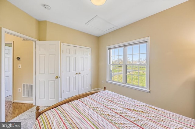 26368 Pennfields Dr, Orange, VA 22960 - bedroom featuring wood finished floors, a closet, attic access, visible vents, and baseboards