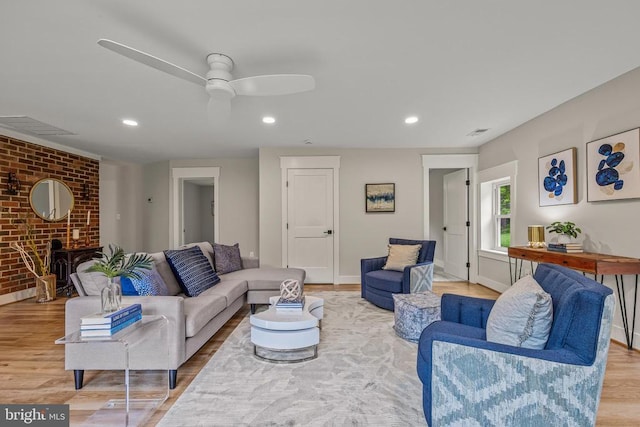 - living area featuring light wood-style floors, a fireplace, brick wall, recessed lighting, and ceiling fan