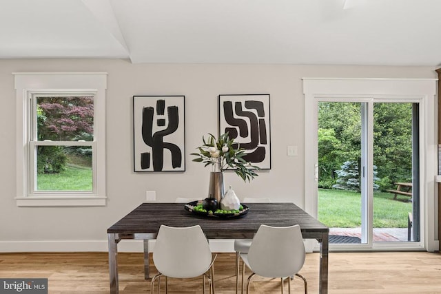  - dining room with healthy amount of natural light and wood finished floors