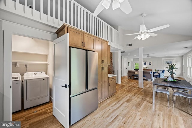  - kitchen featuring freestanding refrigerator, ceiling fan, washer and clothes dryer, light wood-style flooring, and high vaulted ceiling