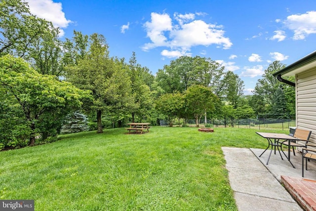  - view of yard featuring an outdoor fire pit, a patio area, and view of wooded area