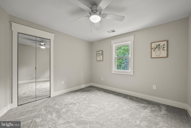  - unfurnished bedroom featuring carpet, a closet, and ceiling fan