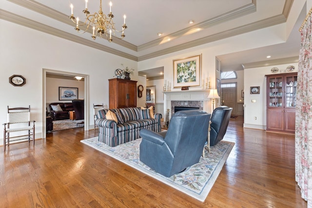 273 Bel Grene Dr, Fishersville, VA 22939 - living room featuring a premium fireplace, an inviting chandelier, a raised ceiling, and wood finished floors
