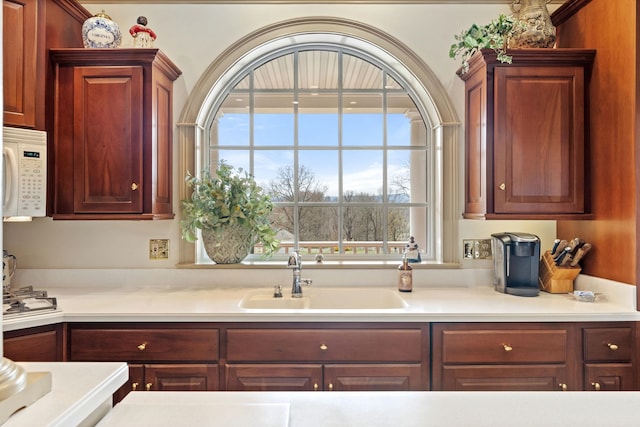 273 Bel Grene Dr, Fishersville, VA 22939 - kitchen featuring light countertops, white microwave, stainless steel gas stovetop, and a sink