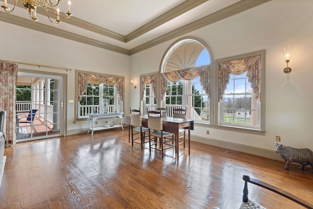 273 Bel Grene Dr, Fishersville, VA 22939 - dining room with wood finished floors, a tray ceiling, a notable chandelier, visible vents, and ornamental molding