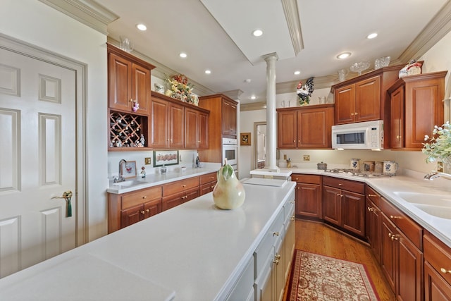 273 Bel Grene Dr, Fishersville, VA 22939 - kitchen featuring light wood finished floors, ornate columns, a sink, white appliances, and light countertops