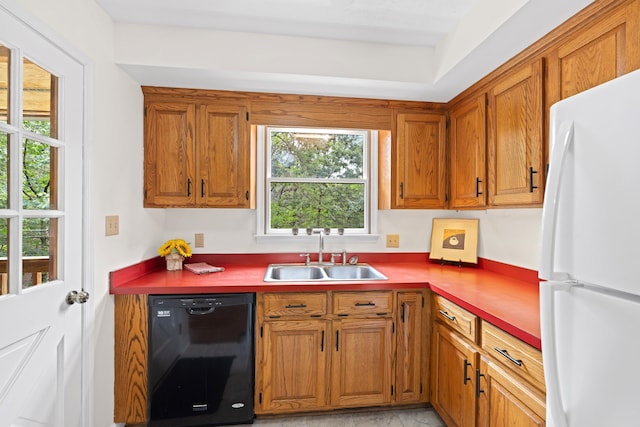 409 Thomas St, Staunton, VA 24401 - kitchen with freestanding refrigerator, dishwasher, a sink, and brown cabinetry