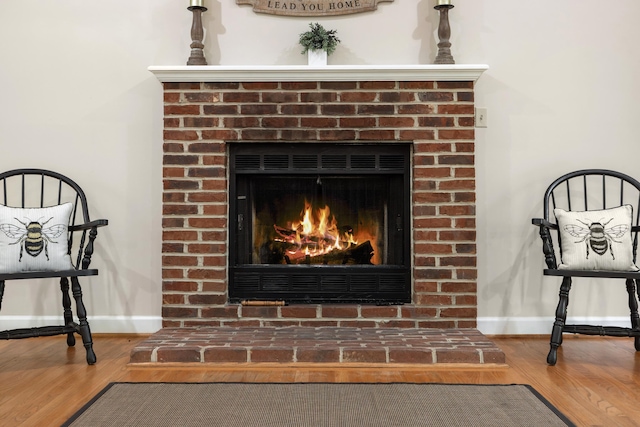 409 Thomas St, Staunton, VA 24401 - detailed view of baseboards, a brick fireplace, and wood finished floors