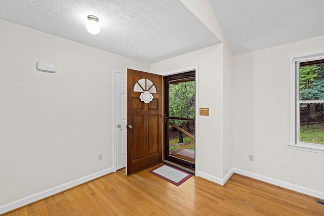 409 Thomas St, Staunton, VA 24401 - entryway with light wood finished floors, baseboards, healthy amount of natural light, and a textured ceiling
