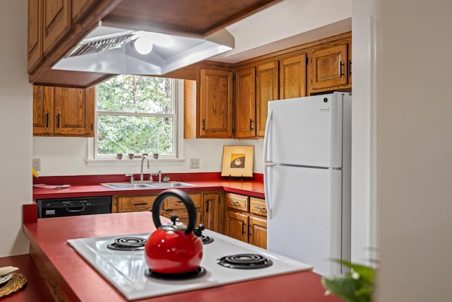 409 Thomas St, Staunton, VA 24401 - kitchen with freestanding refrigerator, a sink, brown cabinetry, and dishwasher