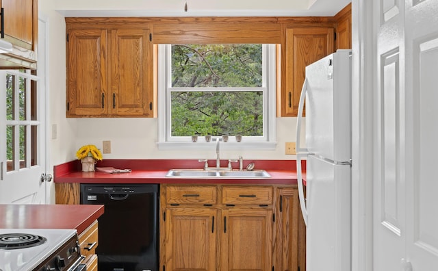 409 Thomas St, Staunton, VA 24401 - kitchen featuring black dishwasher, a sink, freestanding refrigerator, and brown cabinets
