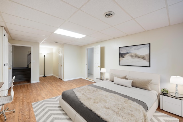 409 Thomas St, Staunton, VA 24401 - bedroom with light wood-type flooring, a paneled ceiling, and baseboards