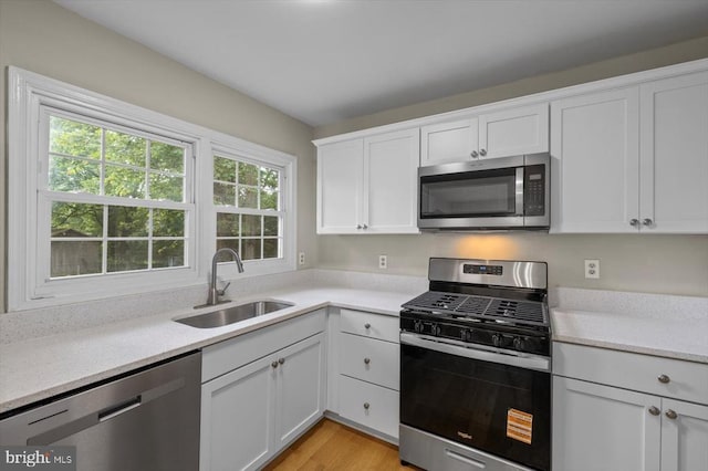 809 Sherwood Ln, Fredericksburg, VA 22407 - kitchen featuring stainless steel appliances, light countertops, white cabinets, and light wood-style floors
