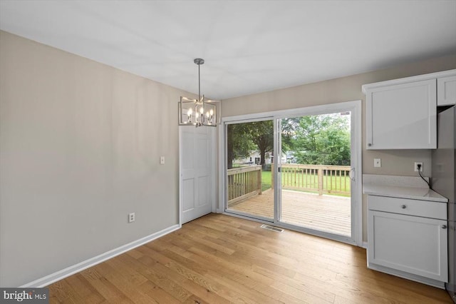 809 Sherwood Ln, Fredericksburg, VA 22407 - unfurnished dining area with a chandelier and light wood-style floors