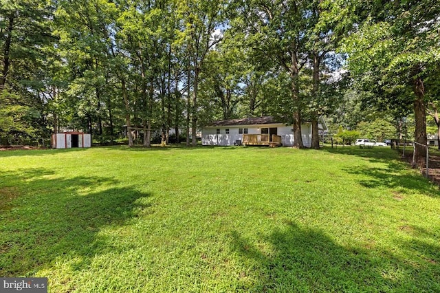809 Sherwood Ln, Fredericksburg, VA 22407 - view of yard with a storage shed, a deck, and view of scattered trees