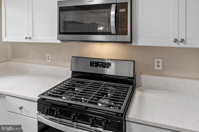 809 Sherwood Ln, Fredericksburg, VA 22407 - kitchen view of stainless steel appliances, white cabinets, and light stone countertops