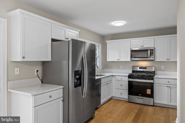 809 Sherwood Ln, Fredericksburg, VA 22407 - kitchen featuring appliances with stainless steel finishes, white cabinets, light countertops, and light wood-style floors