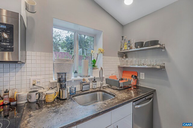 316 6 1/2 St, Charlottesville, VA 22903 - kitchen with stainless steel appliances, a sink, tasteful backsplash, lofted ceiling, and white cabinets