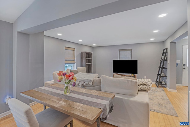 dining space with baseboards, light wood-style floors, and recessed lighting