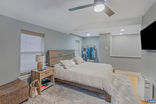 bedroom featuring wood finished floors, a ceiling fan, and vaulted ceiling