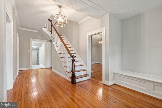 105 Washington St E, Remington, VA 22734 - entryway featuring a chandelier, stairway, hardwood / wood-style flooring, baseboards, and a textured ceiling