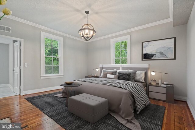105 Washington St E, Remington, VA 22734 - bedroom featuring multiple windows, hardwood / wood-style floors, a chandelier, crown molding, and a textured ceiling