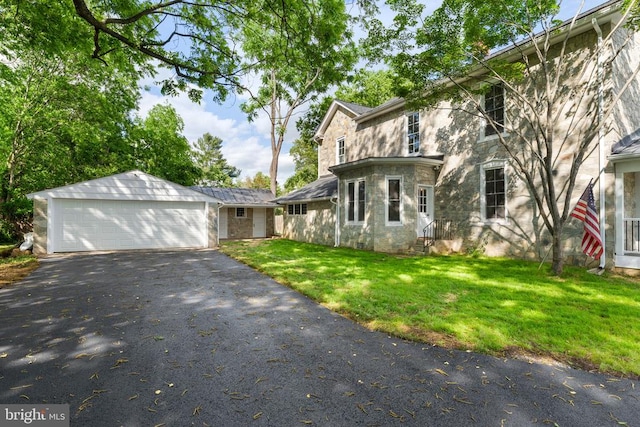 105 Washington St E, Remington, VA 22734 - traditional-style home with entry steps, an outdoor structure, a front lawn, a detached garage, and stone siding