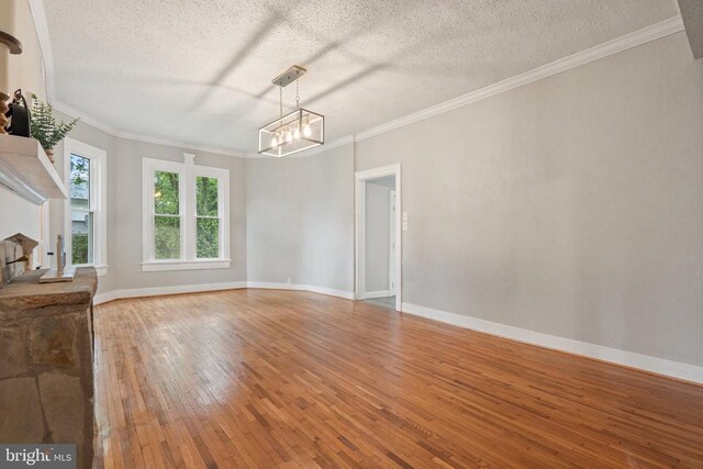 105 Washington St E, Remington, VA 22734 - empty room with a textured ceiling, light wood finished floors, ornamental molding, and a chandelier