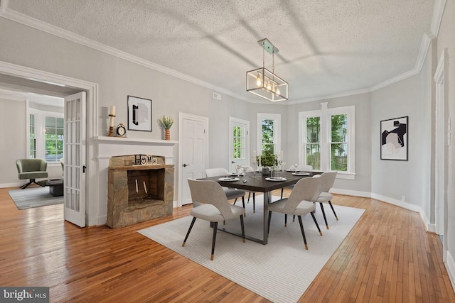 105 Washington St E, Remington, VA 22734 - dining space featuring light wood-style flooring, ornamental molding, a chandelier, baseboards, and a textured ceiling