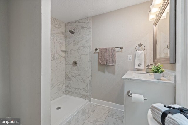 105 Washington St E, Remington, VA 22734 - bathroom featuring tiled shower, marble look tile flooring, vanity, and a textured ceiling