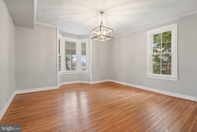 105 Washington St E, Remington, VA 22734 - spare room featuring a chandelier, hardwood / wood-style flooring, a textured ceiling, and crown molding