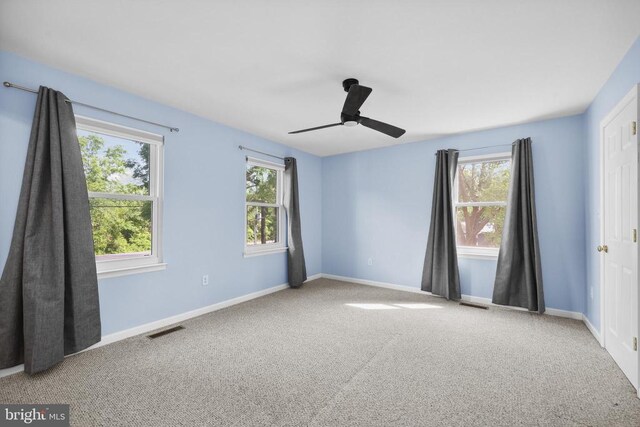  - carpeted empty room with healthy amount of natural light and ceiling fan