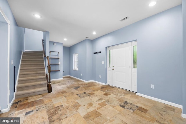  - entryway featuring stone tile floors, stairs, and recessed lighting